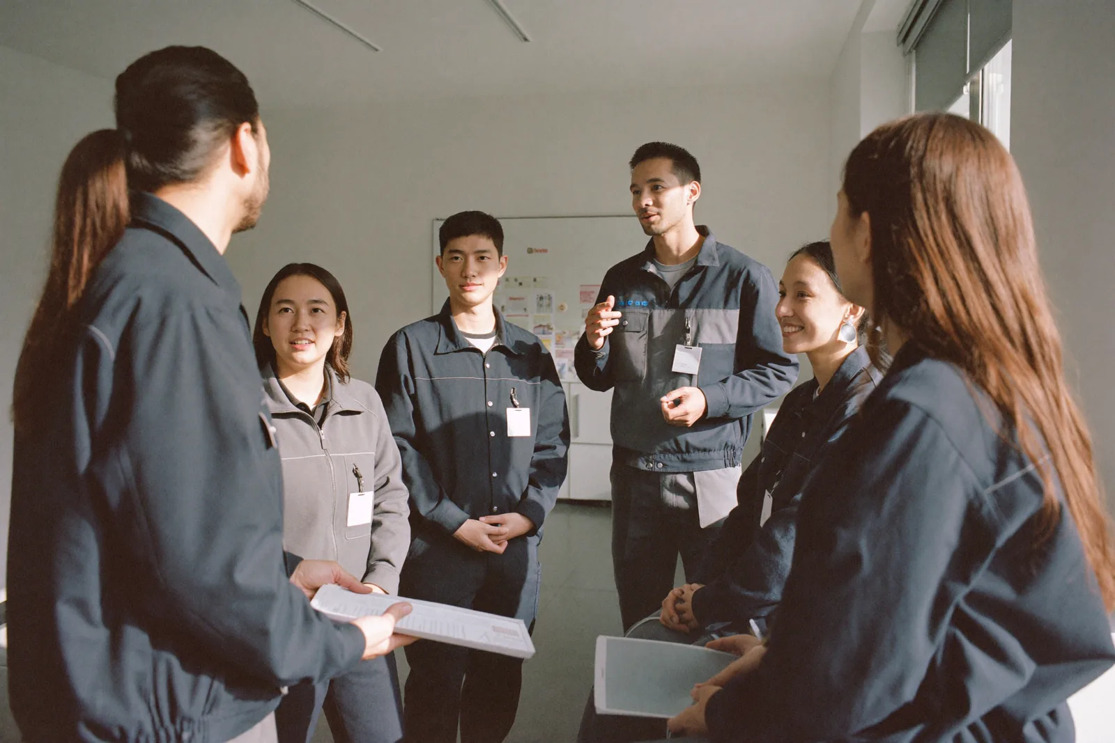 Diverse team of foreign workers at a morning meeting in a Canadian workplace