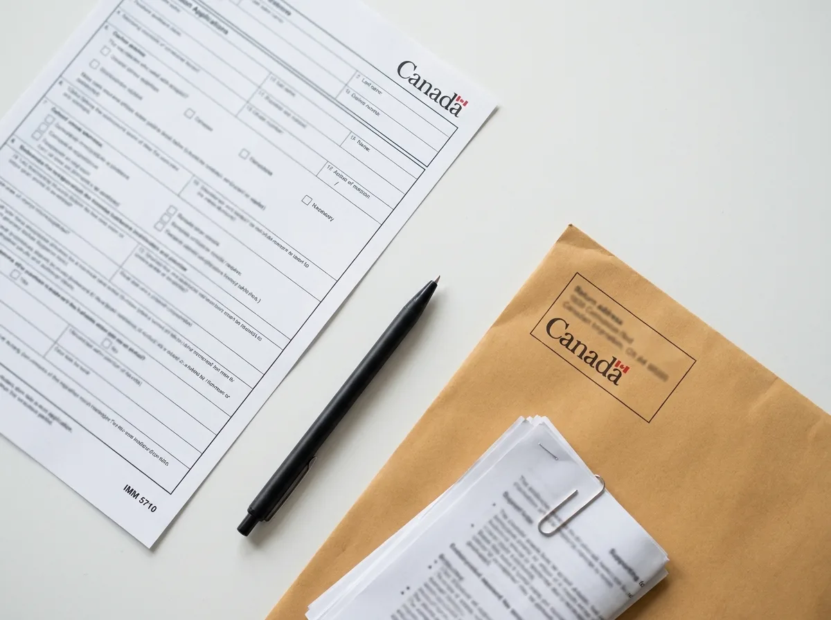Super Visa Application Documents IRCC application form IMM 5710 and supporting documents on a clean desk.