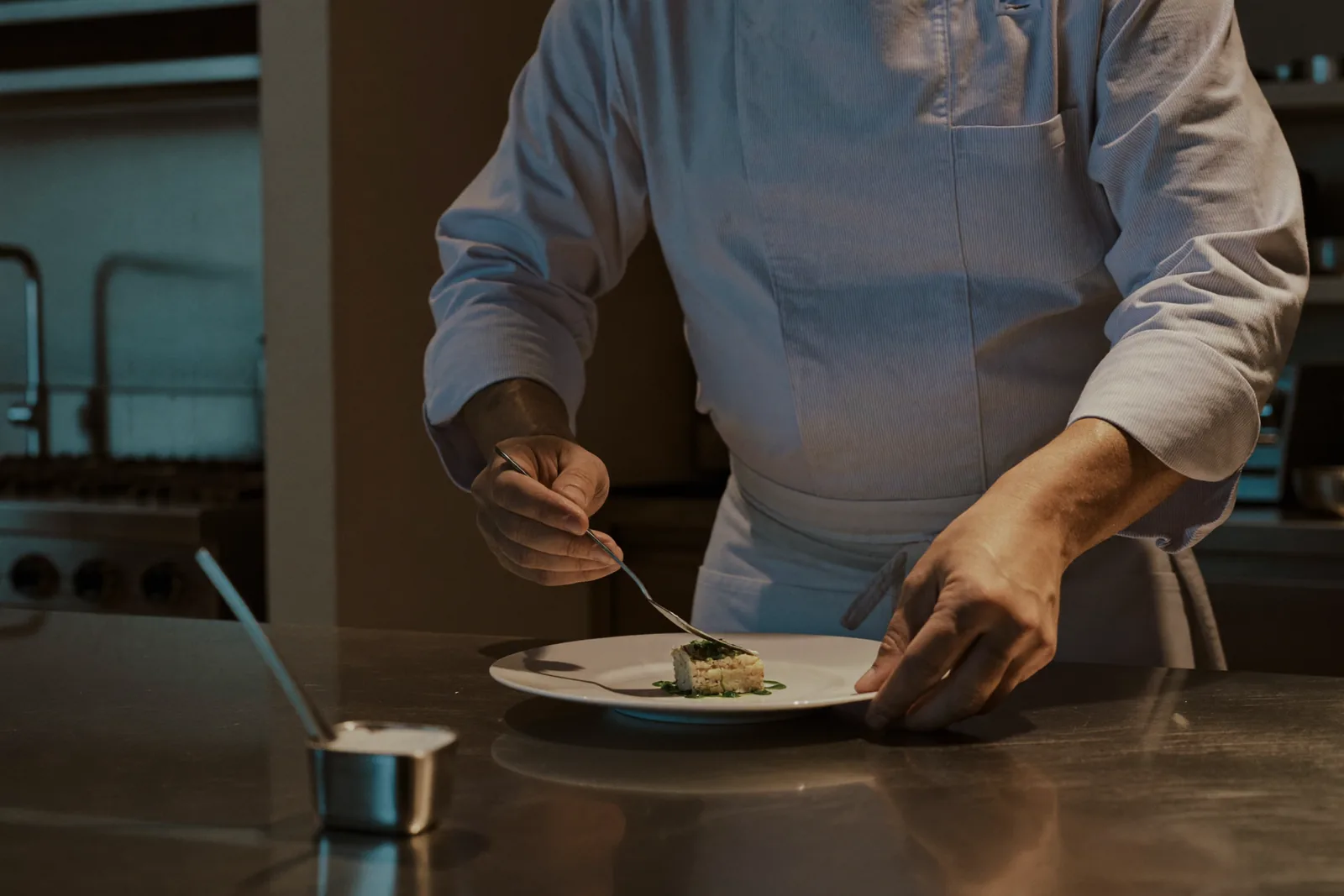 Chef working in a Canadian restaurant kitchen on an employer-specific work permit