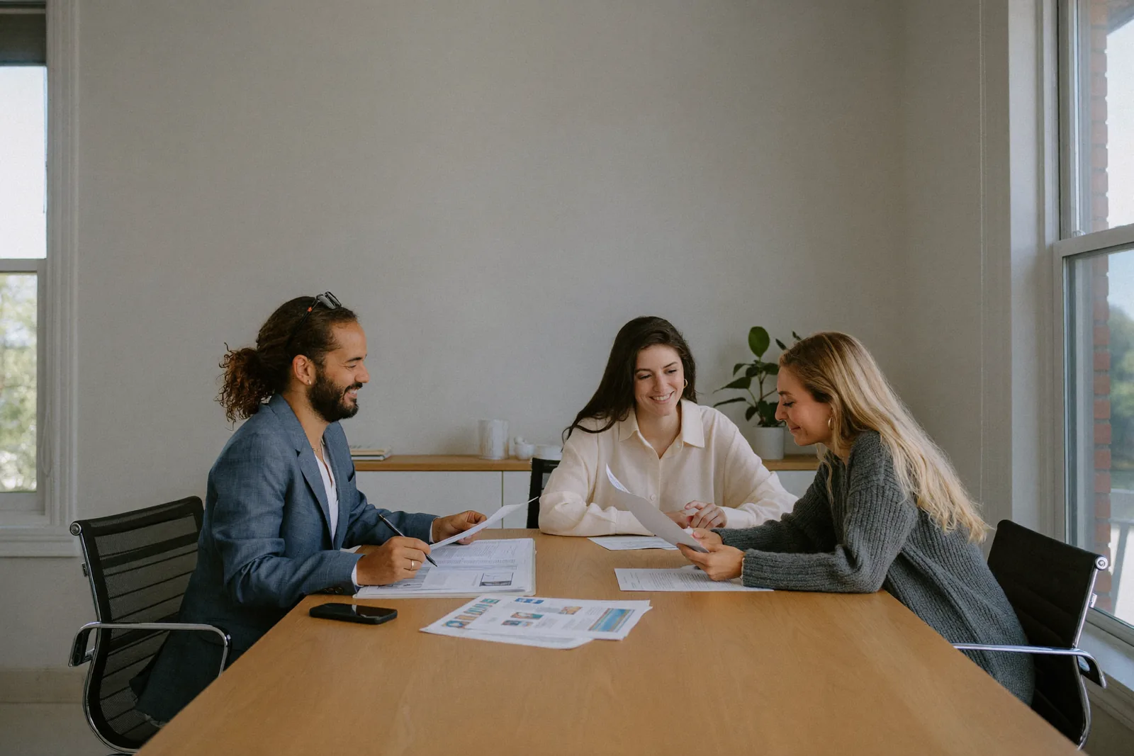 Couple reviewing a Canada work permit application with a TopNation consultant in Edmonton